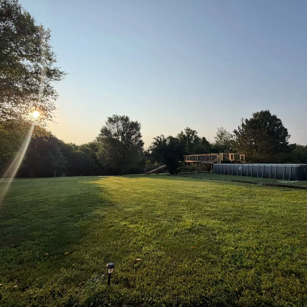 Sunset over the lawn with the dock diving pool in the distance